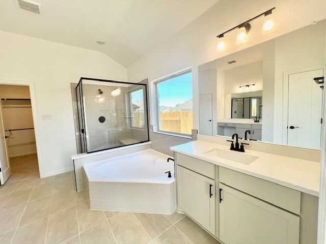 bathroom with vanity, tile patterned flooring, plus walk in shower, and lofted ceiling