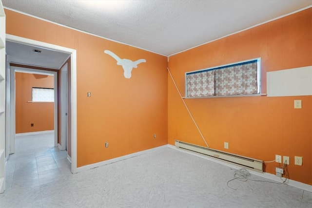 empty room with a textured ceiling and a baseboard radiator