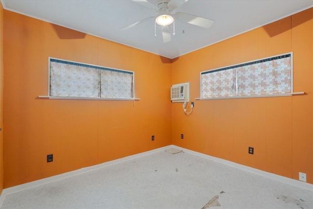 spare room with an AC wall unit and ceiling fan