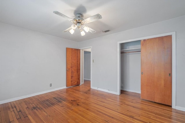 unfurnished bedroom featuring a closet, ceiling fan, and light hardwood / wood-style flooring