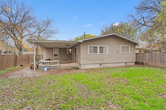 back of house with a lawn