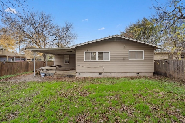 rear view of house with a lawn