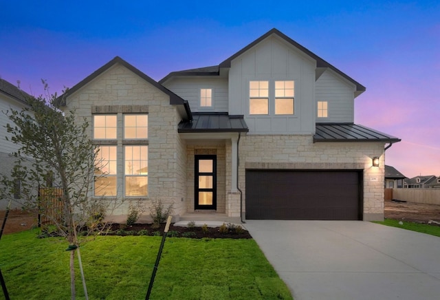 view of front of house with a yard and a garage