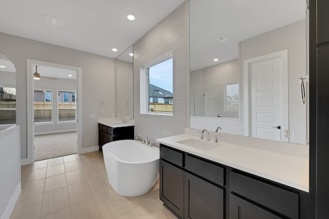 bathroom featuring ceiling fan, a healthy amount of sunlight, tile patterned flooring, and vanity