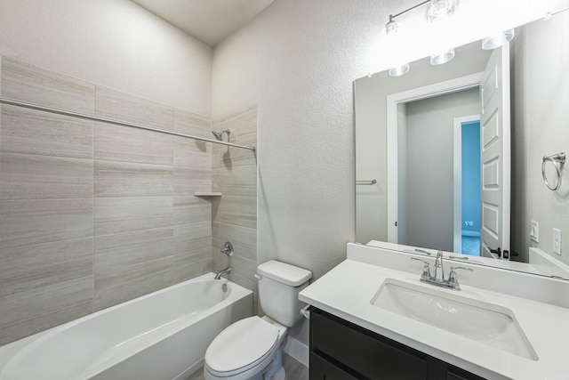 full bathroom with toilet, tiled shower / bath combo, and vanity