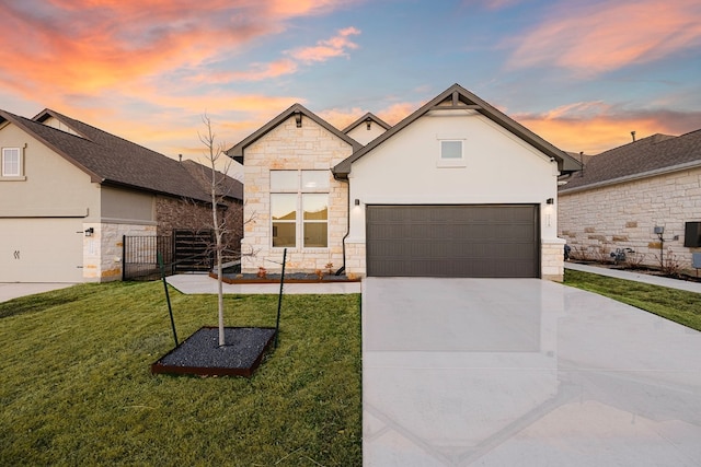 view of front of house with a garage and a lawn