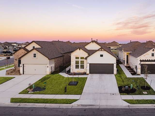 view of front of property featuring a lawn and a garage