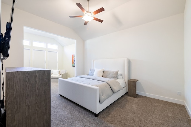 bedroom with lofted ceiling, dark carpet, and ceiling fan