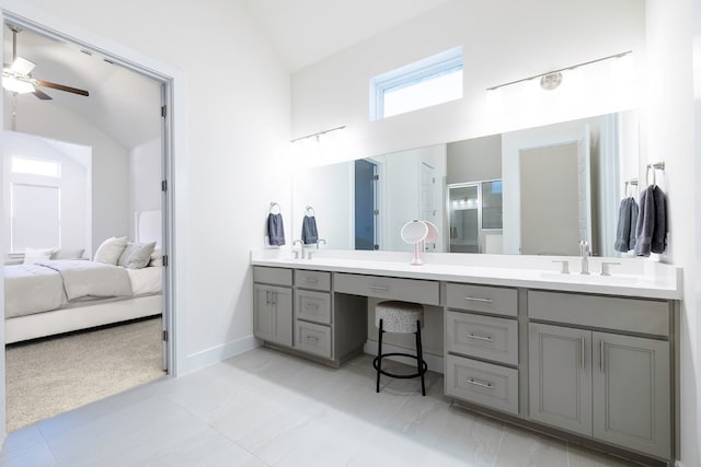 bathroom with vaulted ceiling, ceiling fan, a shower with door, and vanity