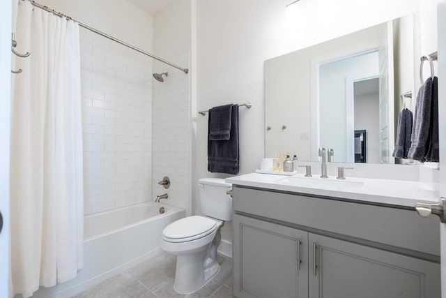 full bathroom featuring shower / bath combination with curtain, tile patterned floors, vanity, and toilet