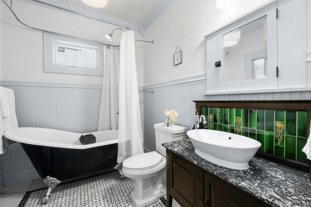 bathroom with ornamental molding, vanity, and toilet