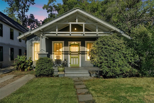 view of front of home featuring a yard and covered porch