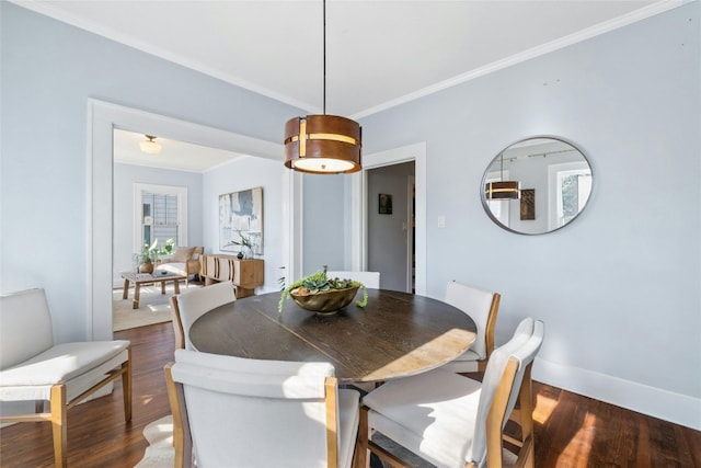 dining area featuring crown molding and dark hardwood / wood-style floors