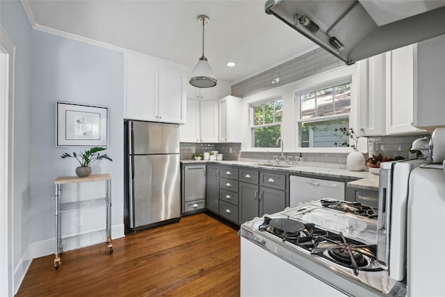 kitchen with pendant lighting, sink, white appliances, and white cabinetry