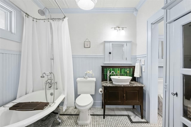 full bathroom with ornamental molding, shower / bathtub combination with curtain, vanity, and toilet