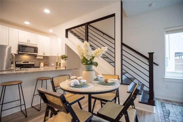 dining room with dark hardwood / wood-style flooring