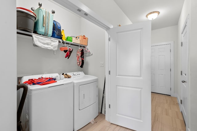 clothes washing area with separate washer and dryer