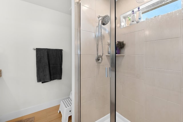 bathroom featuring wood-type flooring and a shower with shower door