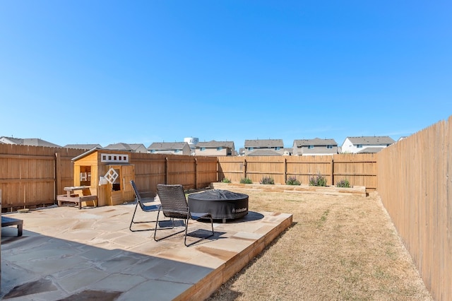 view of yard with a patio and a fire pit