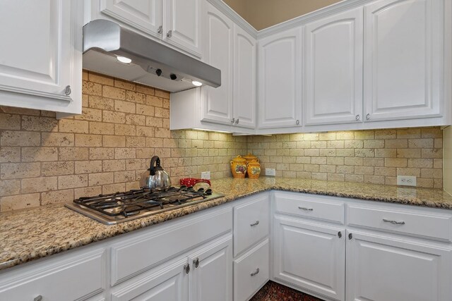 kitchen featuring decorative backsplash, white cabinetry, stainless steel gas cooktop, and light stone counters