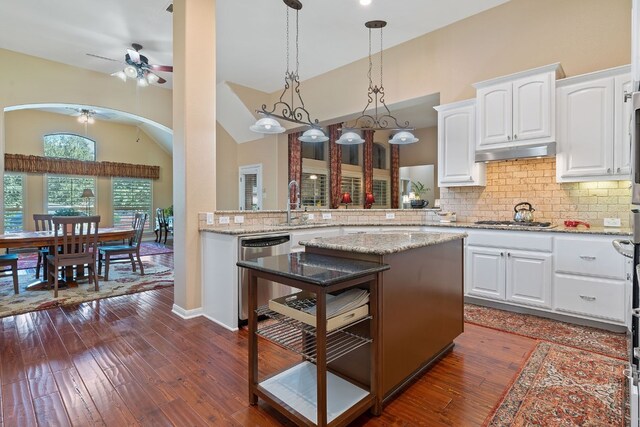 kitchen featuring light stone counters, white cabinets, appliances with stainless steel finishes, and dark hardwood / wood-style flooring