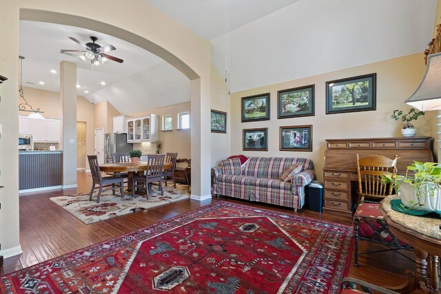 living room featuring lofted ceiling, dark hardwood / wood-style floors, and ceiling fan