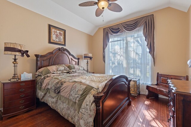 bedroom with vaulted ceiling, multiple windows, and dark hardwood / wood-style floors