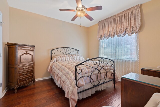 bedroom featuring ceiling fan and dark wood-type flooring