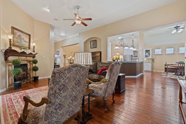 living room featuring ceiling fan and dark wood-type flooring