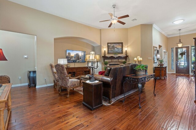 living room featuring ceiling fan, crown molding, and dark hardwood / wood-style flooring