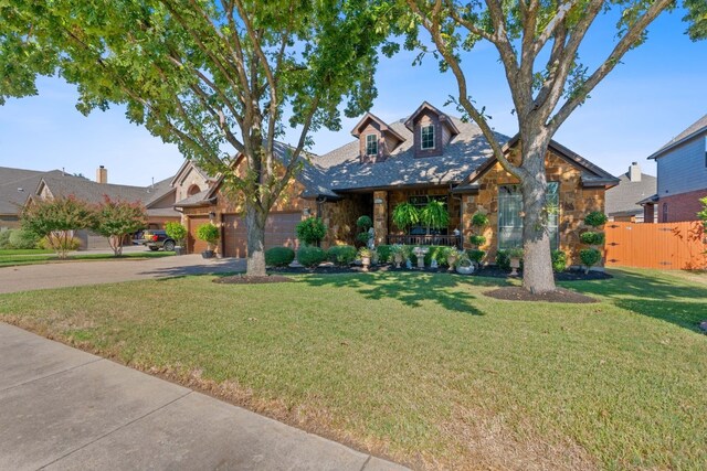 view of front of house with a garage and a front lawn