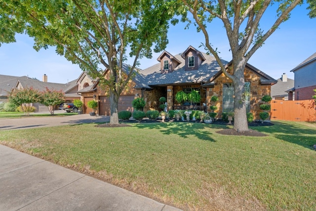 view of front of house with a garage and a front lawn