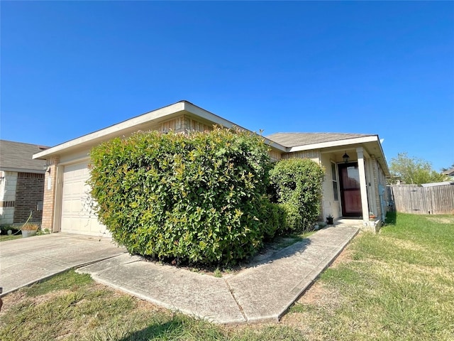 view of front of property with a garage and a front lawn