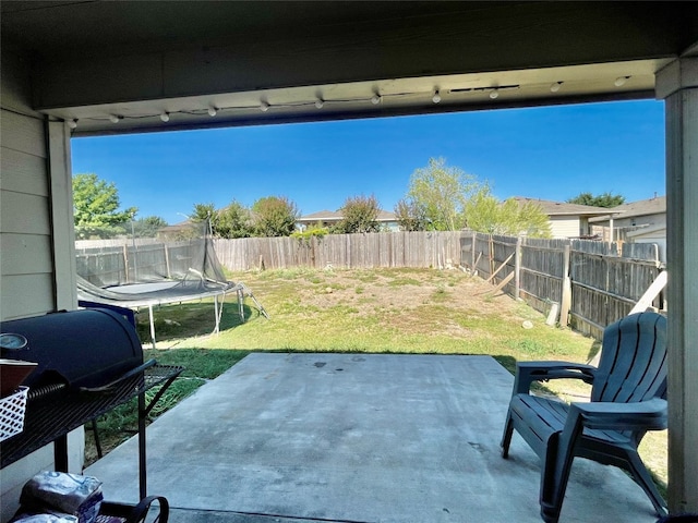 view of patio featuring a trampoline and area for grilling