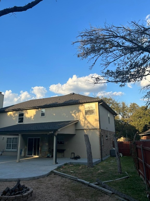 back of property with a patio