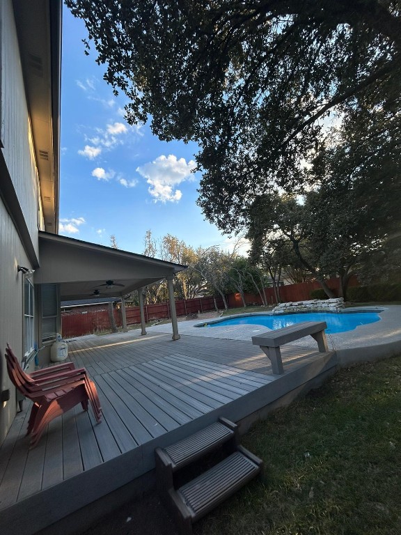 view of swimming pool with a deck