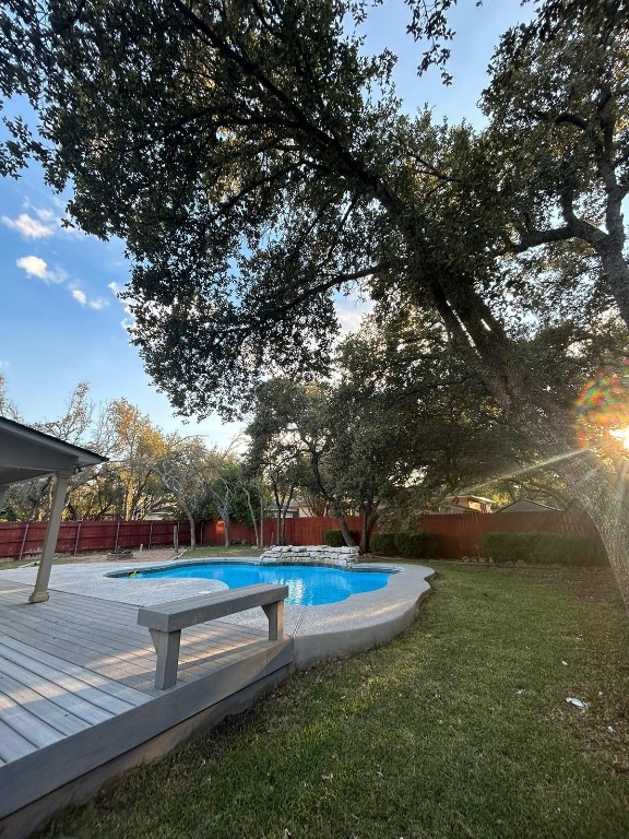 view of pool featuring a deck and a yard