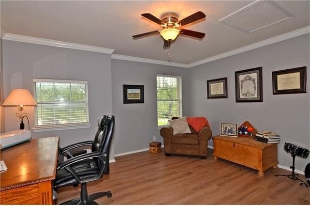 office area featuring ornamental molding, wood-type flooring, and ceiling fan