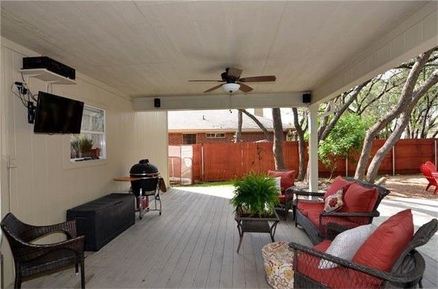 view of patio with ceiling fan and a deck