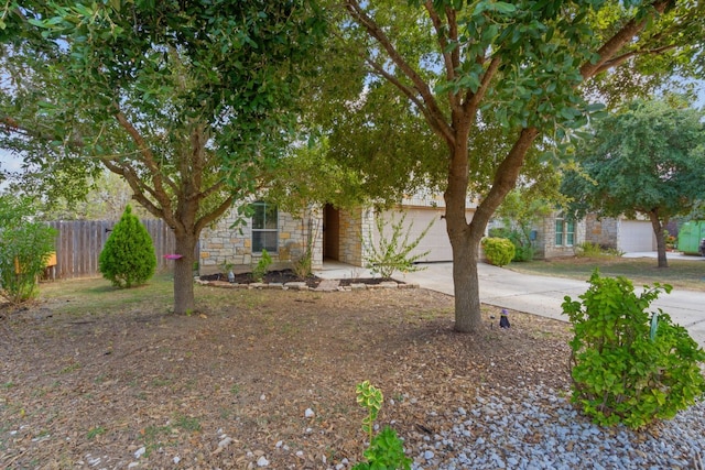 obstructed view of property with a garage