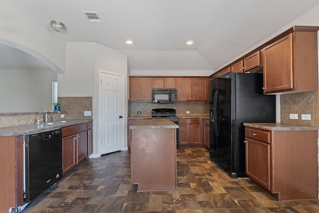 kitchen with backsplash, black appliances, sink, vaulted ceiling, and a kitchen island