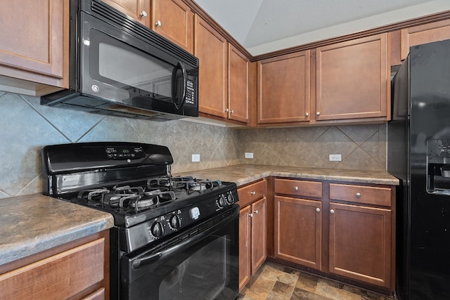 kitchen with black appliances and tasteful backsplash