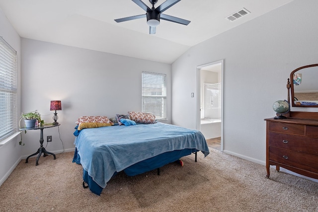 carpeted bedroom featuring ensuite bath, ceiling fan, and lofted ceiling