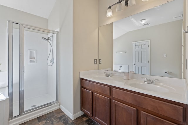 bathroom featuring a shower with door, vanity, and lofted ceiling