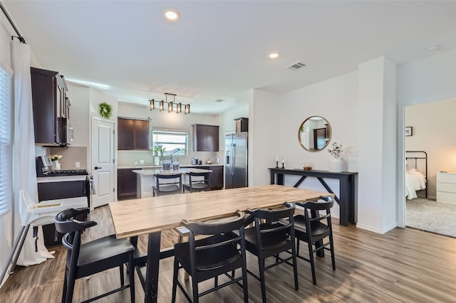 dining room with hardwood / wood-style flooring