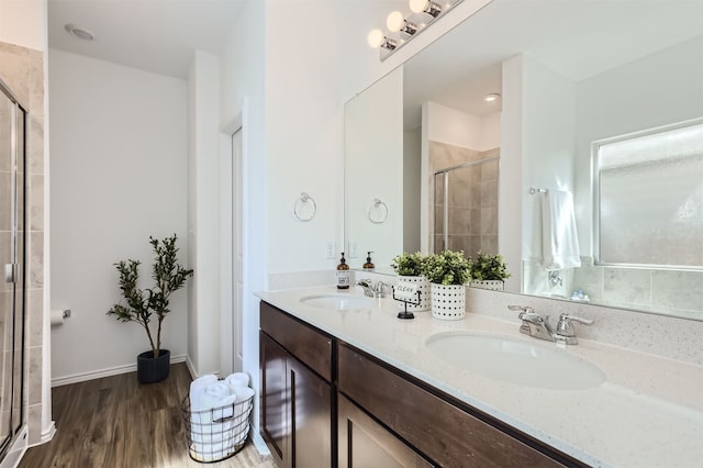 bathroom with walk in shower, hardwood / wood-style flooring, and vanity