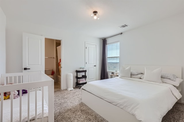 carpeted bedroom featuring ensuite bathroom