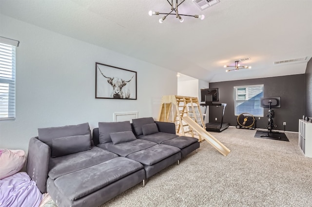 living area featuring an inviting chandelier, visible vents, and carpet floors