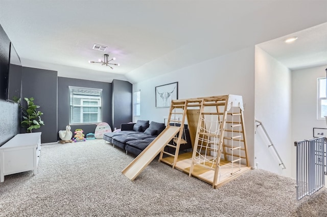 carpeted bedroom featuring lofted ceiling and multiple windows