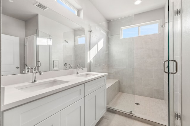 bathroom with an enclosed shower, tile patterned floors, and vanity